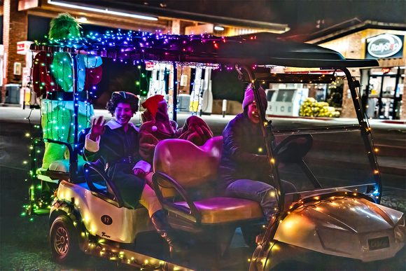 3 People on a Golf Cart with lots of Lights